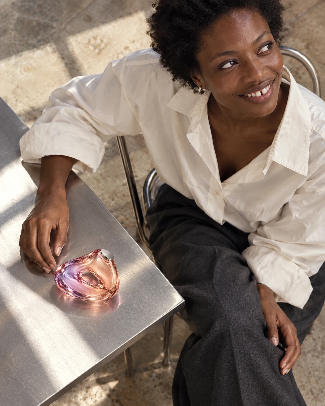 An overhead campaign portrait of a woman in a white shirt